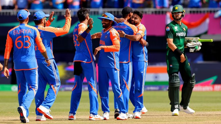 Cricket players celebrate on the field after a close match Between India vs Pakistan. Jasprit Bumrah is in the foreground, raising his arms in victory.